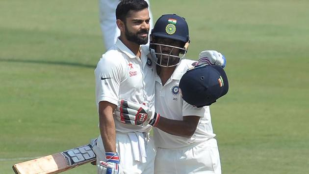 India's Wriddhiman Saha(R) congratulates Virat Kohli after scoring his double century against Bangladesh.(AFP)