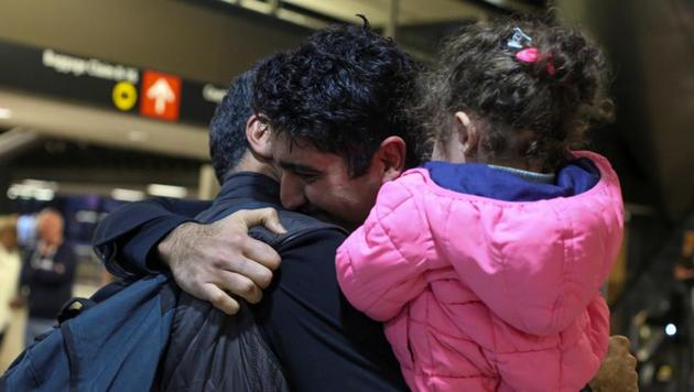 Iranian citizen and US green card holder Cyrus Khosravi (C) greets his brother, Hamidreza Khosravi (L), and niece, Dena Khosravi (R), 2, after they were detained for additional screening following their arrival to Seattle-Tacoma International Airport to visit Cyrus, during a pause in US President Donald Trump's travel ban in SeaTac, Washington. (REUTERS) Iranian citizen and US green card holder Cyrus Khosravi (C) greets his brother, Hamidreza Khosravi (L), and niece, Dena Khosravi (R), 2, after they were detained for additional screening following their arrival to Seattle-Tacoma International Airport to visit Cyrus, during a pause in US President Donald Trump's travel ban in SeaTac, Washington. (REUTERS)