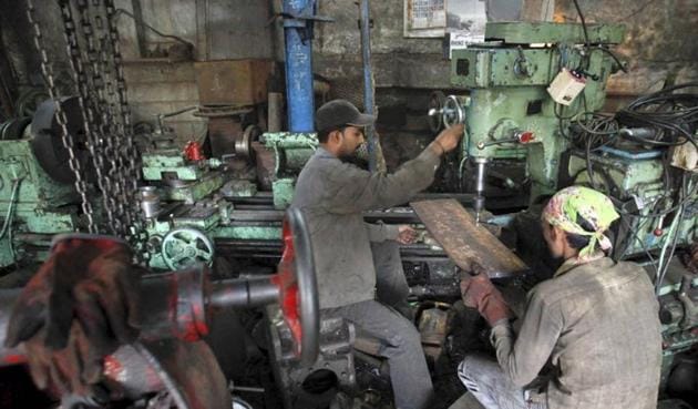 Workers make gear parts for cranes inside a workshop in Mumbai. Indian industrial output contracted to four-month low of 0.4% in December 2016.(Reuters)