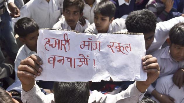 Students of a government school in Shahbad Dairy at a protest on Friday, demanding new school building. The school building was declared unsafe by the government last year.(Sushil Kumar/HT Photo)