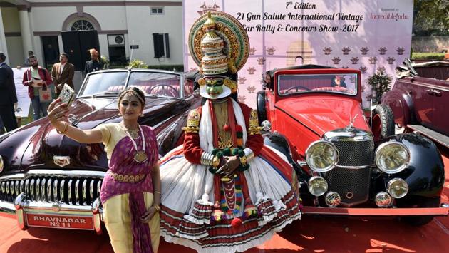 Classical dancers take a selfie in front of vintage cars during the media preview for the upcoming 21 Gun Salute vintage car rally in New Delhi, India. The 21 Gun Salute International Vintage Car Rally & Concours Show will commence on February 17 at the India Gate. (Mohd Zakir/HT PHOTO)