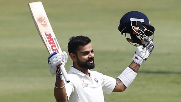 Virat Kohli raises his bat to celebrate his double century against Bangladesh in Hyderabad. He surpassed Don Bradman and Rahul Dravid by scoring double hundreds in four successive series. Bradman and Dravid in three.(AP)