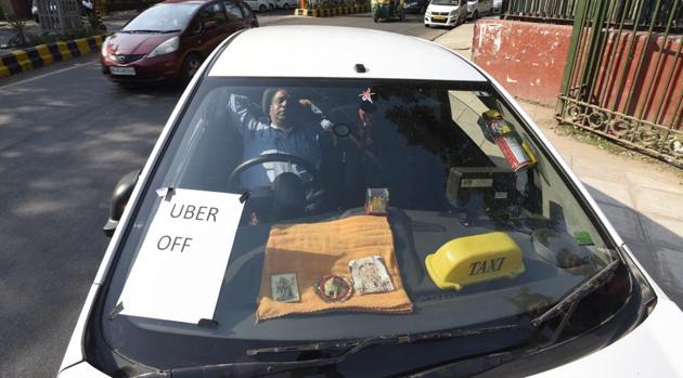 A taxi driver sits in his car on the second day of the strike against app-based cab aggregators, at Tolstoy Marg near Jantar Mantar in New Delhi.(Sonu Mehta/HT PHOTO)