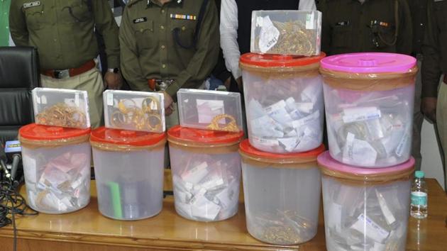 Police recovered 30 kg gold, some of the cash, two pistols and four rounds from the accused. Two motorcycles, and a car were also seized from them. (Parveen Kumar/HT Photo) Police recovered 30 kg gold, some of the cash, two pistols and four rounds from the accused. Two motorcycles, and a car were also seized from them. (Parveen Kumar/HT Photo)