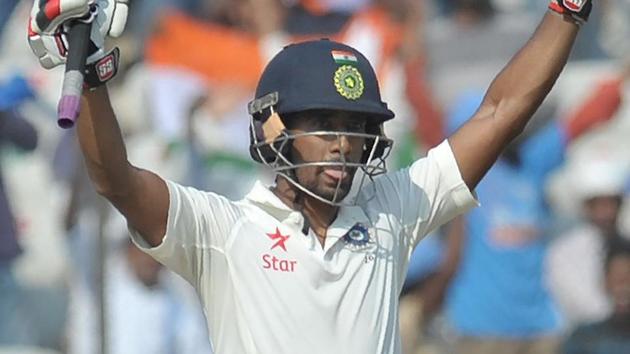 India's Wriddhiman Saha celebrates after scoring his century in the one-off Test against Bangladesh.(AFP)