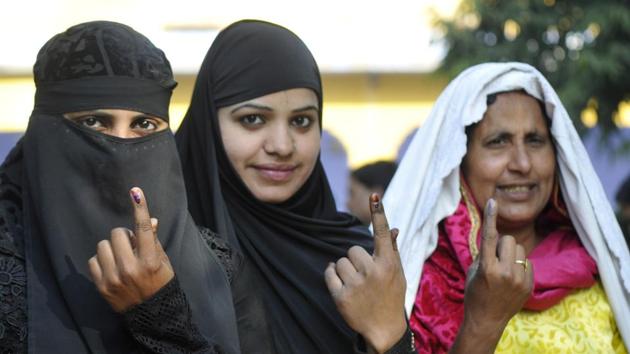 Muslim women show their ink marked finger after casting their vote at Janata Inter College in Jewar constituency of Greater Noida on Saturday. (Sunil Ghosh / HT photo)