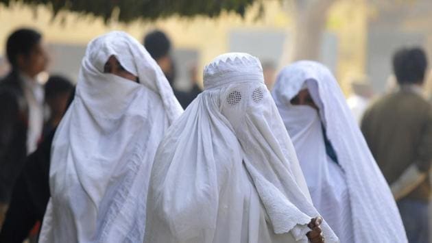 Muslim women make their way to caste votes at Janata Inter College in Jewar constituency of Greater Noida on Saturday. (sunil gosh / Ht photo)