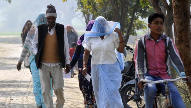 Voters arrive to cast their vote in Parsaul at Jewar constituency in Greater Noida on Saturday. Uttar Pradesh saw a 64% voter turnout in first phase of assembly polls, the Election Commission said on Saturday. (Sunil Ghosh / Ht photo )