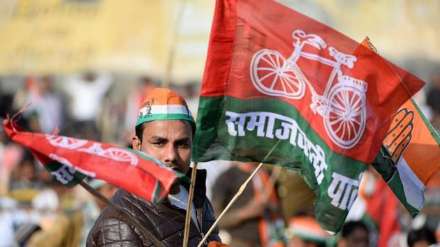 A supporter of the Congress and Samajwadi political parties waves party flags during an election rally by Congress Party leader Rahul Gandhi ahead of state assembly elections in Uttar Pradesh, in Ghaziabad on February 8, 2016.(AFP Photo)