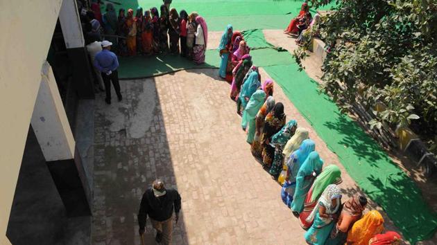 Women standing in queue to cast their vote at a polling booth in Bisada town of Dadri in Greater Noida on Saturday. The town is politically sensitive after grabbing national headlines in 2015, over lynching of a Muslim man by a Hindu mob on suspicion of storing beef at his place. (Burhaan Kinu / HT photo)