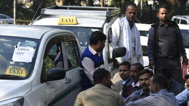 Uber drivers sit their parked cars in Tolstoy Marg in Central Delhi on Saturday. (Sonu Mehta/HT Photo) Uber drivers sit their parked cars in Tolstoy Marg in Central Delhi on Saturday. (Sonu Mehta/HT Photo)