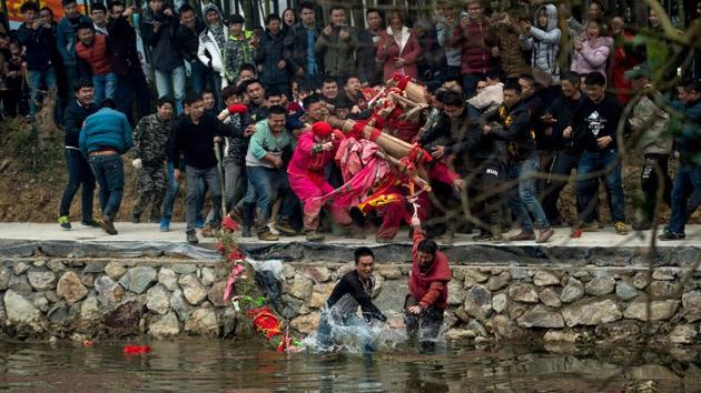 The rock-turned-Buddha likes to run away, the legend says, and people believe beating it can make it stay. (AFP Photo) The rock-turned-Buddha likes to run away, the legend says, and people believe beating it can make it stay. (AFP Photo)