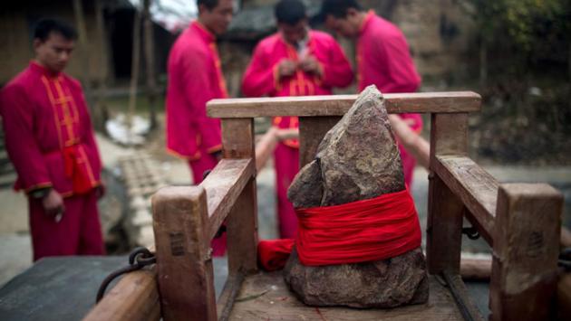 A rock, regarded by villagers as the centuries-old Buddha, is tied to a wooden palanquin. (AFP Photo) A rock, regarded by villagers as the centuries-old Buddha, is tied to a wooden palanquin. (AFP Photo)