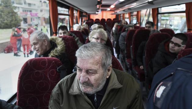 Residents of Kordelio district are seen aboard a bus after authorities ordered the evacuation of the area in order to defuse a 500-pound unexploded World War II bomb, in Thessaloniki, Greece Sunday, Feb 12.(AP Photo)