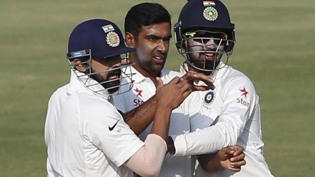 India cricket team's Ravichandran Ashwin (centre) celebrates with teammates Lokesh Rahul (right) and Murali Vijay after taking the wicket of Bangladesh national cricket team’s Mominul Haque during the fourth day of the one-off match in Hyderabad on Sunday.(AP)