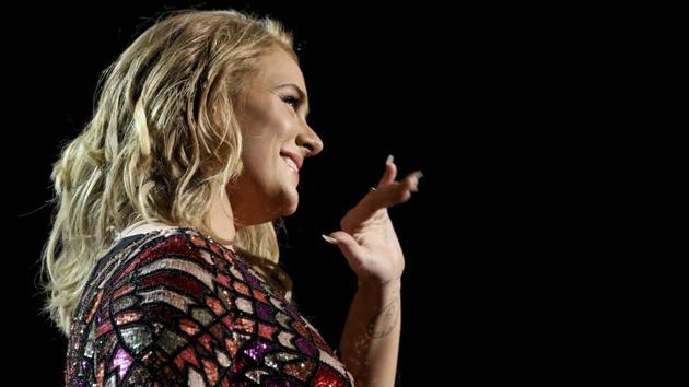 Adele waves to the audience as she performs Hello at the awards extravaganza. (AP)