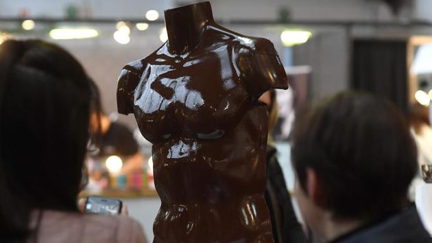 Visitors look at a chocolate creation in the shape of a torso on February 10, 2017 on the opening day of the Brussels Chocolate Fair in the Belgian capital, Brussels. (EMMANUEL DUNAND / AFP)