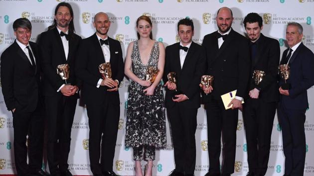 US film producers Fred Berger (third from left), Jordan Horowitz (third right) and Marc Platt (right) pose with the award for Best Film for La La Land, alongside US actress Emma Stone (centre), US director Damien Chazelle (second right), Swedish cinematographer Linus Sandgre (second left) US composer Justin Hurwitz (fourth right). (AFP)