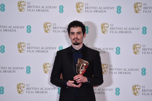 US director Damien Chazelle poses with the award for a Director for his work on the film La La Land. (AFP)