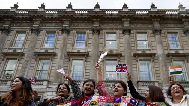 Supporters of Prime Minister Narendra Modi wave flags and cheer at a rally in Whitehall, London. (File photo).(AFP) Supporters of Prime Minister Narendra Modi wave flags and cheer at a rally in Whitehall, London. (File photo).(AFP)