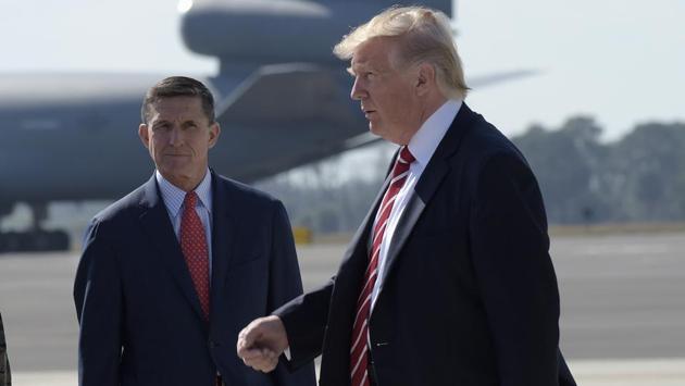 President Donald Trump passes National Security Adviser Michael Flynn as he arrives at MacDill Air Force Base in Tampa, Florida on February 12.(AP)