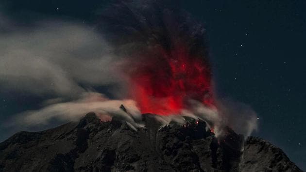 In this timed-exposure night photo taken early on February 12, 2017, Mount Sinabung volcano spews reddish smoke and ash, as seen from the Karo district in North Sumatra province. (AFP) In this timed-exposure night photo taken early on February 12, 2017, Mount Sinabung volcano spews reddish smoke and ash, as seen from the Karo district in North Sumatra province. (AFP)