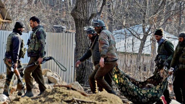 The Special Operation Group of Jammu and Kashmir police carrying the body of a militant which was recovered from the rubble of a destroyed house where militants were hiding during an encounter at Frisal area of Kulgam district of South Kashmir on Sunday. (PTI) The Special Operation Group of Jammu and Kashmir police carrying the body of a militant which was recovered from the rubble of a destroyed house where militants were hiding during an encounter at Frisal area of Kulgam district of South Kashmir on Sunday. (PTI)