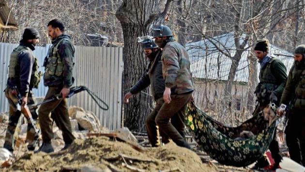 Special Operation Group (SOG) of Jammu and Kashmir police carry the body of a militant recovered from the rubbles of destroyed house where militants were hiding during an encounter at Frisal area of Kulgam district of South Kashmir on Sunday.(PTI File Photo)