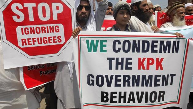 Afghan refugees living in Pakistan protest against their repatriation, in Peshawar, Pakistan, in August 2016. Rights group says Pakistan is forcing refugees home to an uncertain future and war, while the UN refugee agency is complicit, giving them money to return and adding to the pressure to leave the relative safety of Pakistan. (AP File) Afghan refugees living in Pakistan protest against their repatriation, in Peshawar, Pakistan, in August 2016. Rights group says Pakistan is forcing refugees home to an uncertain future and war, while the UN refugee agency is complicit, giving them money to return and adding to the pressure to leave the relative safety of Pakistan. (AP File)