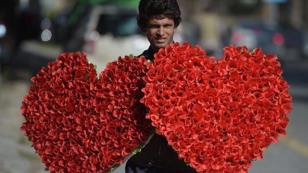 A Pakistani vendor carries heart-shaped bouquets for sale ahead of Valentine's Day along a street in Islamabad on February 13, 2017. (AFP) A Pakistani vendor carries heart-shaped bouquets for sale ahead of Valentine's Day along a street in Islamabad on February 13, 2017. (AFP)
