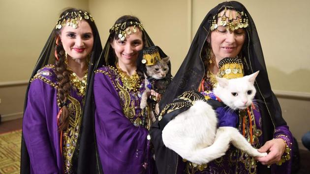 Women with their cats dressed in the fashion of Armenia participate in the World Fashion Presents segment of the 14th Annual New York Pet Fashion Show (TIMOTHY A. CLARY / AFP)