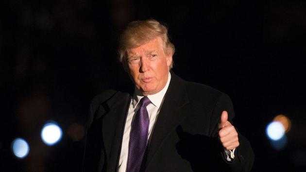 US President Donald Trump walks from Marine One on the South Lawn of the White House as he returns from his weekend trip to Mar-a-Lago, on February 12, 2017, in Washington, DC.(AFP)