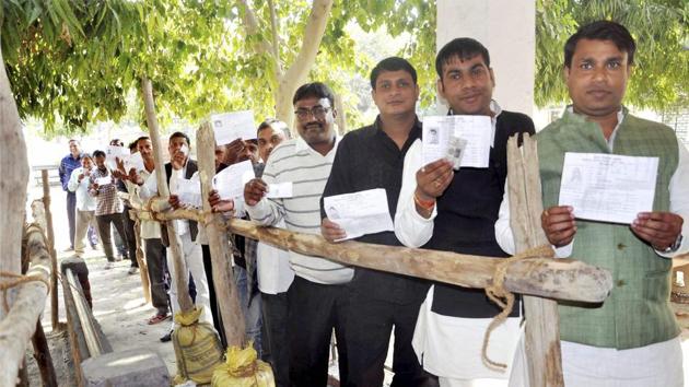 People wait in a queue to cast votes at a polling station during the first phase of assembly polls in Uttar Pradesh on February 11.(PTI file photo)