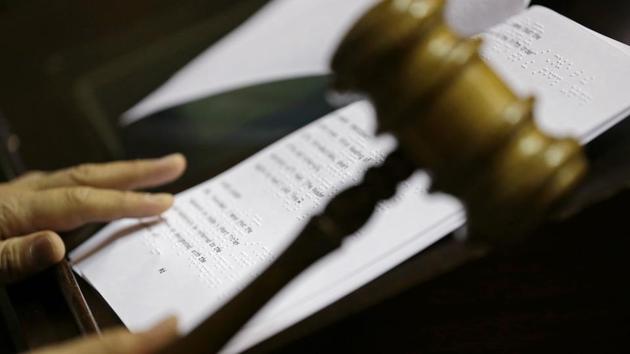 Washington Lt. Gov.-elect Cyrus Habib holds the gavel next to a braille practice script, Thursday, Jan. 5, 2017, during a practice session to test technical equipment in Olympia, Wash. Habib, who will preside over the Senate, will be Washington's first blind lieutenant governor, and the Senate has undergone a makeover that incorporates Braille into that chamber's floor sessions that will allow Habib to know by the touch of his finger which lawmaker is seeking to be recognized to speak. Habib is replacing Lt. Gov. Brad Owen, who is retiring. (AP Photo/Ted S. Warren)(AP)