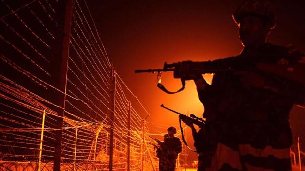 BSF soldiers patrol along a border fence at an outpost along the Line of Control (LOC) between India-Pakistan.(AFP File Photo)