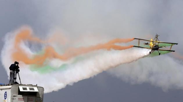 A cameraman films as Skycat Wingwalkers from the Scandinavian Airshow aerobatic team perform at the opening ceremony. The five-day event ends Saturday. (AP) A cameraman films as Skycat Wingwalkers from the Scandinavian Airshow aerobatic team perform at the opening ceremony. The five-day event ends Saturday. (AP)