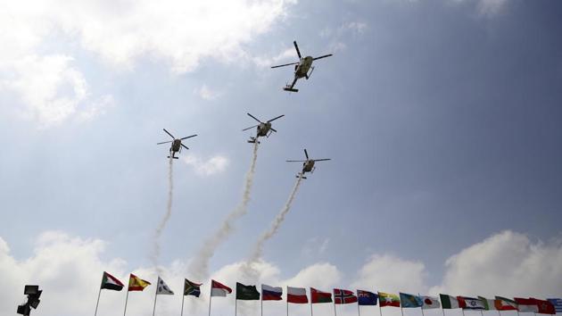 Indigenously manufactured Indian Air Force Dhruv helicopters fly over flags of participating countries at the opening ceremony of Aero India 2017 at Yelahanka air base in Bangalore. (AP) Indigenously manufactured Indian Air Force Dhruv helicopters fly over flags of participating countries at the opening ceremony of Aero India 2017 at Yelahanka air base in Bangalore. (AP)
