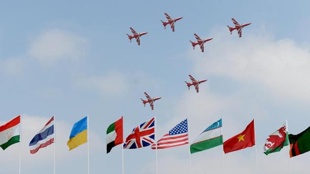 Visitors watch the Surya Kirans aerobatic team of the Indian Air Force during an aerial display over the skies of Yelahanka Air Force Station. (AFP) Visitors watch the Surya Kirans aerobatic team of the Indian Air Force during an aerial display over the skies of Yelahanka Air Force Station. (AFP)
