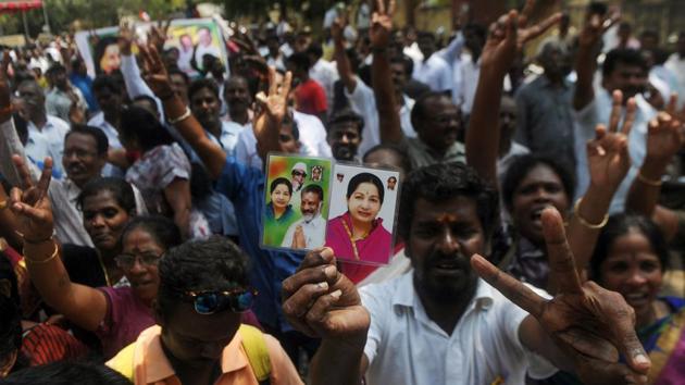 AIADMK supporters celebrate in front of acting chief minister O Panneerselvam’s residence in Chennai on Tuesday.(AFP Photo)