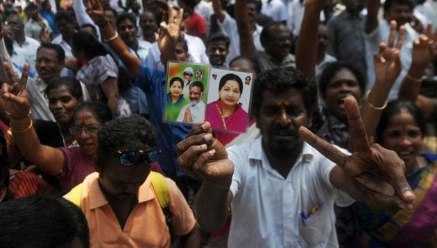 Supporters of the AIADMK celebrate in front of the residence of acting chief minister O Panneerselvam in Chennai after the Supreme Court convicted party general secretary VK Sasikala in a corruption case on Tuesday.(AFP)
