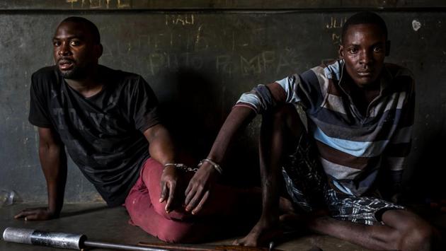Nature, first prize: Two rhino poachers apprehended by an anti-poaching team in Mozambique close to Kruger National Park border. (Brent Stirton / National Geographic Magazine)