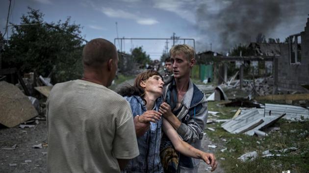 Long Term Project, first prize: Citizens in the village of Luhanskaya after an air strike. (Valery Melnikov, Rossiya Segodnya )