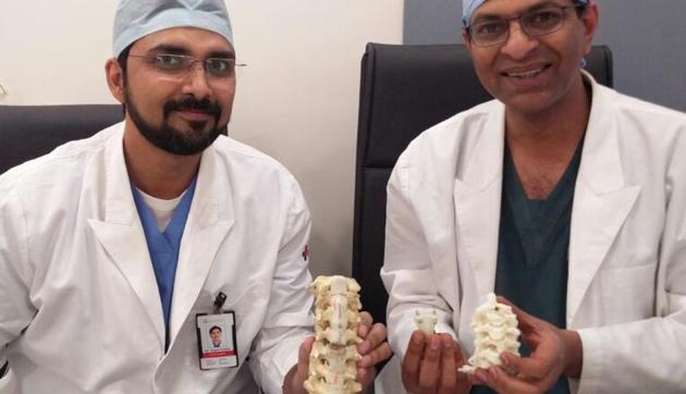 (From Left) Dr Gopal Kumar, consultant, head and neck onco-surgeon, and Dr V Anand Naik, senior consultant, spine surgery bone and joint, Medanta-The Medicity, Gurgaon, hold up a 3D-printed titanium vertebrae