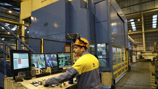 A worker operates a press at Tata Steel's new robotic welding line at their Automotive Service Centre in Wednesfield, Britain, on Wednesday. (REUTERS) A worker operates a press at Tata Steel's new robotic welding line at their Automotive Service Centre in Wednesfield, Britain, on Wednesday. (REUTERS)