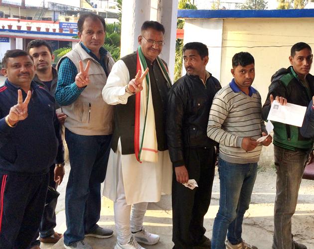 BJP leader Ganesh Joshi (centre) stand in a queue to cast his vote in Dehradun. (HT Photo) BJP leader Ganesh Joshi (centre) stand in a queue to cast his vote in Dehradun. (HT Photo)