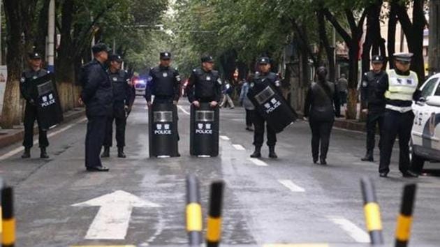 File photo of policemen standing guard behind a barricade blocking the street leading to the site of an explosives attack in downtown Urumqi, Xinjiang Uighur Autonomous Region, in May 2014.(Reuters) File photo of policemen standing guard behind a barricade blocking the street leading to the site of an explosives attack in downtown Urumqi, Xinjiang Uighur Autonomous Region, in May 2014.(Reuters)