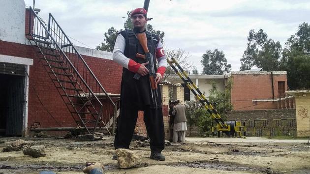 A Pakistani security officer stands alert at the site of a bombing in Ghalanai in the Pakistan's tribal region of Mohmand on Wednesday. (AP) A Pakistani security officer stands alert at the site of a bombing in Ghalanai in the Pakistan's tribal region of Mohmand on Wednesday. (AP)