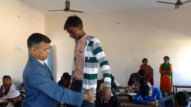Bihar School Examination Board chairman Anand Kishor frisking a student at an examination centre in Patna.