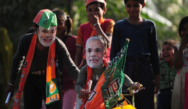 Children play with masks of Prime Minister Narendra Modi in Phulpur village on the outskirts of Allahabad on Wendesday. (AFP) Children play with masks of Prime Minister Narendra Modi in Phulpur village on the outskirts of Allahabad on Wendesday. (AFP)