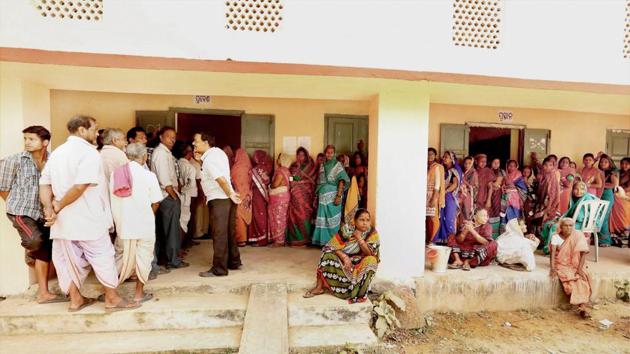 Voters queue in line to vote during the second phase of Odisha Panchayat polls at Balipatana village on Feb 15.(PTI Photo)